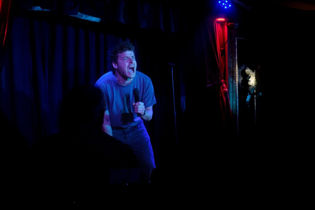 Audience enjoying Laughs on Tap comedy night at Speakeasy Theatre