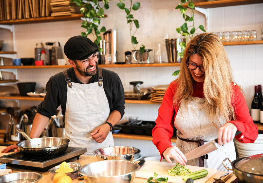 Participants learning to cook global dishes in refugee cooking classes at Free to Feed, Melbourne.